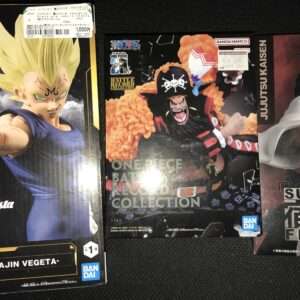 Three boxes of anime figures on a display shelf: Majin Vegeta Grandista box on the left, One Piece Battle Record Collection in the center, and Sukuna figure from Jujutsu Kaisen on the right.