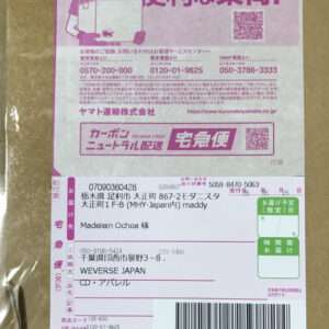 Pink Japanese shipping label on a cardboard box: includes barcode, QR codes, tracking numbers, and recipient Madelein Ochoa; delivery fields and company info visible.