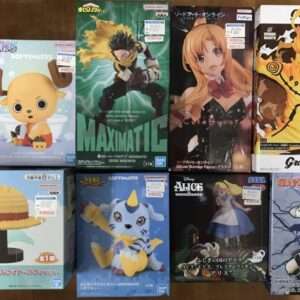 Assorted boxed anime figure figurines arranged on a wooden floor, featuring chibi and stylized characters.