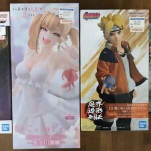 Four boxed anime figures lined up on a wooden surface; from left, a Grandista box featuring a white-haired character with a spear.
