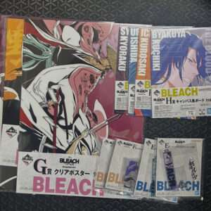 Assorted Bleach manga posters and booklets spread on a dark, patterned floor, featuring bold pink title and character illustrations.