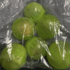 Six neon green translucent plastic balls with small holes, packed in a clear plastic bag.