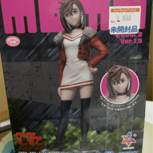 Box featuring a female anime figure in a red jacket and white dress, black knee-high socks, standing with hand on hip; pink packaging and SEGA logo visible.  Articulos Japan (Post Box Japan)