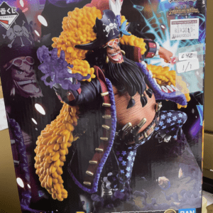 Box art for a One Piece Treasure Cruise figure featuring Marshall D. Teach Blackbeard in a black coat, yellow puffy hair, skull accents, and blue floral pants.