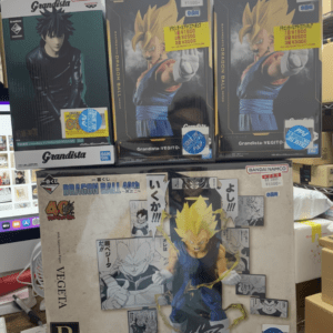 Boxed Dragon Ball Grandista figures on a store shelf: a dark-haired character on the left and Super Saiyan Goku boxes in the center and right.