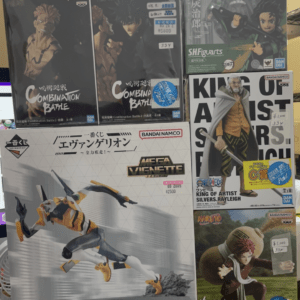 Boxed anime figures on a store shelf: Combinaion Battle Jujutsu Kaisen-style figures by Bandai Namco (dark boxes).