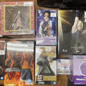 Assorted boxed anime figures arranged on a wooden floor, featuring Bleach, Naruto, One Piece, and Final Fantasy characters.