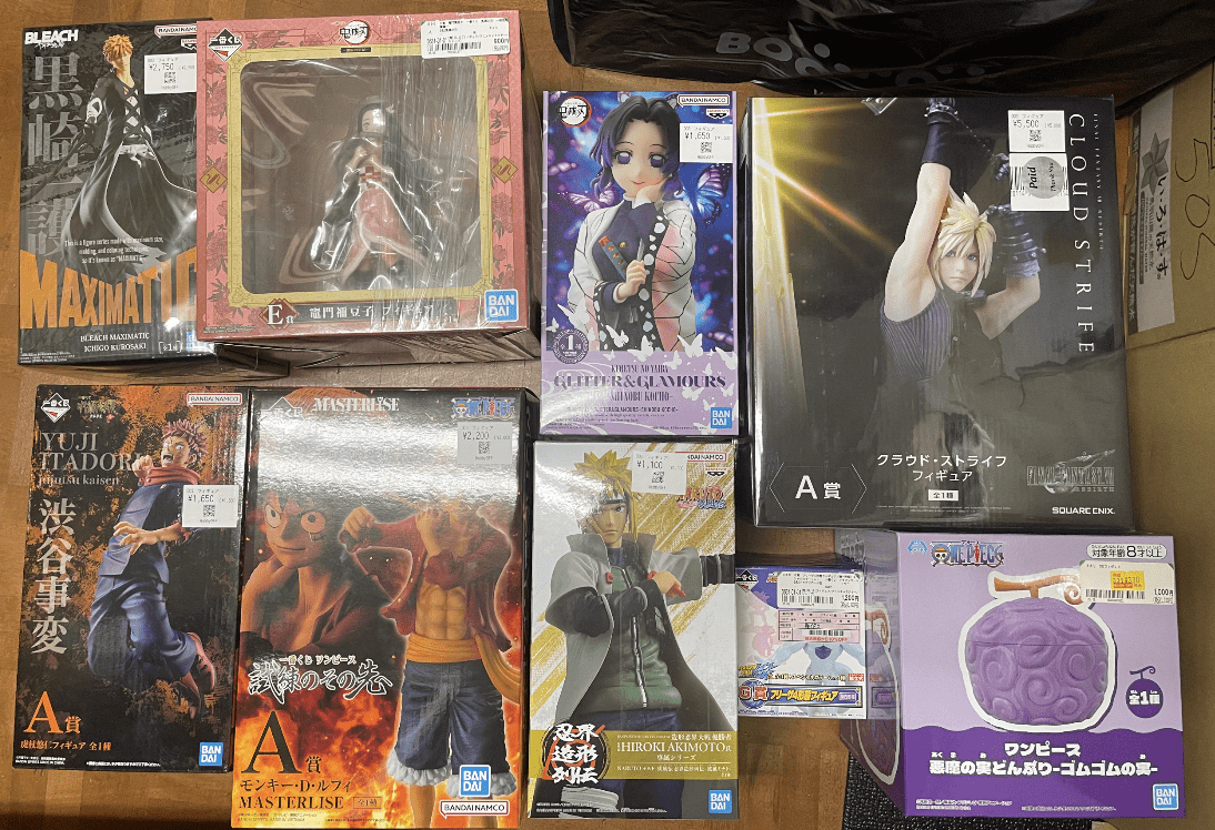 Ver Fotos Recientes 250 - Articulos Japan (post Box Japan) Assorted boxed anime figures arranged on a wooden floor, featuring Bleach, Naruto, One Piece, and Final Fantasy characters. Articulos Japan (Post Box Japan)