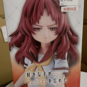 Boxed anime figure of a red-haired schoolgirl in a sailor uniform with a yellow bow, Japanese text on the box front, price sticker top right