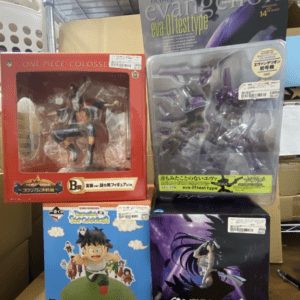 Boxes of anime figures on a store shelf: One Piece Colosseum red box on the left, Evangelion Eva-01 test type purple figure in a clear tray on the top right, Dragon Ball Snap Figure blue box on the bottom left, and Overlord figure box with dark purple art on the bottom right.