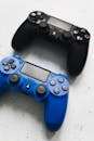 Close-up of black and blue PlayStation controllers. Perfect for gaming enthusiasts.