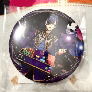 Round enamel pin showing an anime-style character in ornate purple and black clothing with colorful blocks in front and a small purple cat figure nearby, in a plastic wrap.