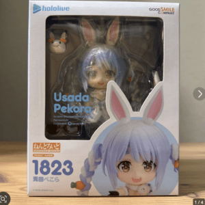 Boxed Hololive Nendoroid figure of Usada Pekora, visible chibi blue-haired bunny-eared character through a clear window, by Good Smile Company.