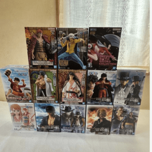 Stacked boxes of One Piece figurines forming a stepped pyramid on a white surface.