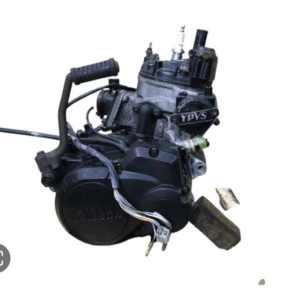 Yamaha motorcycle engine assembly with wiring harness on a white background.