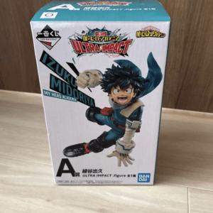 Boxed Izuku Midoriya Ultra Impact action figure from My Hero Academia on a wooden floor, front view of the package.