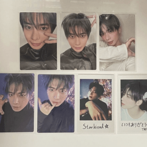 Set of seven Taehyun photo cards in assorted poses, mostly in black outfits; two cards have handwritten captions.