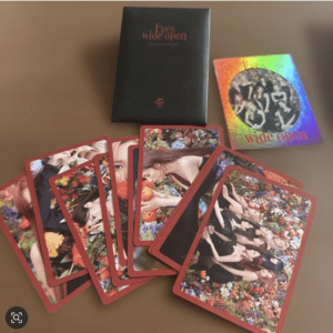Red-bordered photo cards fanned out on a brown table, with a black box labeled 'Eyes wide open' and a rainbow-covered card nearby.