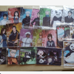 Collection of colorful anime trading cards in plastic sleeves laid out on a table, showing various characters in vibrant backs.