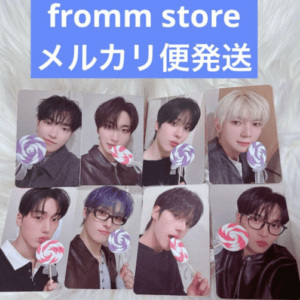 Nine K-pop photocard previews holding swirl lollipops, arranged in a 3x3 grid on a fluffy white background with a blue 'fromm store' banner at top.