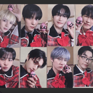 Eight young men in matching red plaid outfits pose in a grid, each holding a pink heart-patterned egg prop.