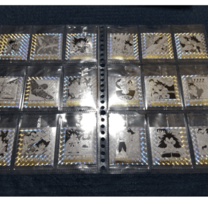 Holographic Dragon Ball trading cards in a binder, each in plastic sleeves on a dark surface.