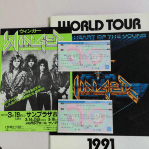 Two retro concert posters with bold neon text and a 'World Tour 1991' design, plus two holographic tickets resting on top.