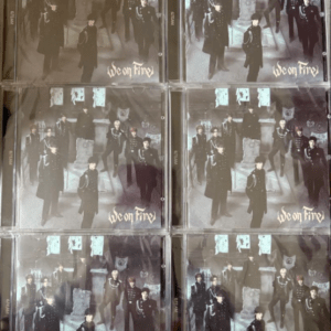 Six CD cases arranged in a 3x2 grid, each showing a dark, gothic group portrait with the title 'We on Fire' in the lower right corner.
