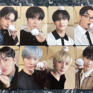 Nine-panel collage of K-pop group members posing with a small white stuffed toy in each panel.