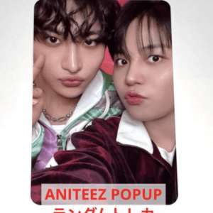 Selfie of two young men posing closely for a promo card, with red 'ANITEEZ POPUP' text and Japanese characters at the bottom