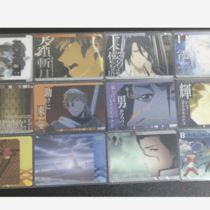 Row of colorful anime trading cards laid out on a dark surface, including Bleach covers.