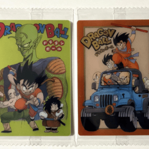 Two Dragon Ball trading cards in plastic sleeves; left card shows Goku with allies on a lime-green background, right card shows Goku in a blue jeep with others on an orange border.  Articulos Japan (Post Box Japan)