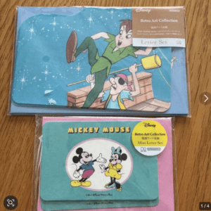 Disney Retro Art Collection Letter Set with Peter Pan scene (top) and Mickey Mouse mini letter set (bottom) in packaging on a wooden surface