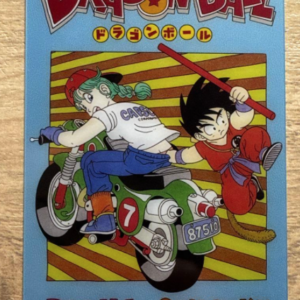 Dragon Ball cover art featuring Bulma on a green motorcycle and Goku with a red rod, blue border and the title logo at top.  Articulos Japan (Post Box Japan)