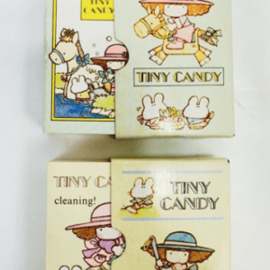 Two vintage Tiny Candy boxes with cartoon children and rabbits, one showing a girl with a sunhat and the other a scene with rabbits.