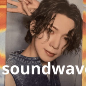 Portrait of a person with short, wet-looking hair making a peace sign with fingers; wearing a denim vest, against a gray backdrop with colorful border and the word 'soundwave' across the bottom.