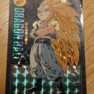 Dragon Ball Z trading card showing a Super Saiyan with spiky golden hair, arms crossed, in yellow top and gray pants, with holographic foil text.
