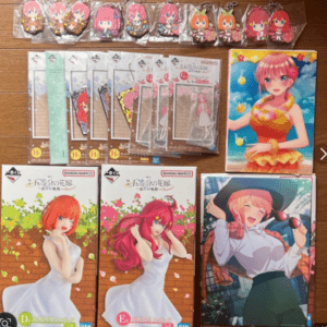 Set of anime character keychains and acrylic stands arranged on a table with colorful art styles.  Articulos Japan (Post Box Japan)