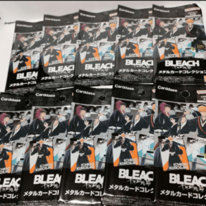 Pile of Bleach metal card collection packs featuring Ichigo Kurosaki artwork spread across a table.