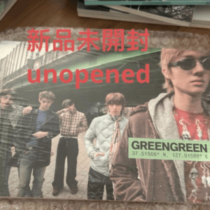 Promotional image of a band album cover with red Japanese text and the word 'unopened' across the front, placed on bubble wrap with a GreensGreen label visible.