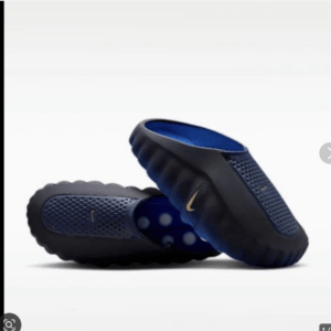 Dark blue Nike slide sandals with textured strap and blue interior on a white background