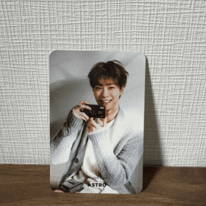 Photo card of a smiling man holding a small camera on a wooden surface; bottom text reads Moon Bin ASTRO.
