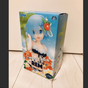Box packaging for a Summer Beach figure featuring a blue-haired anime girl in a black swimsuit with tropical backdrop and flowers.