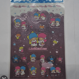 Sticker sheet featuring Sanrio Little Twin Stars characters (blue-haired boy and pink-haired girl) in various poses on a purple background with stars and hearts.