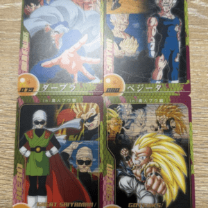 Four Dragon Ball trading cards laid on a wooden table: top row shows Goku and Vegeta; bottom row features Great Saiyaman and Super Saiyan 3 Gotenks.