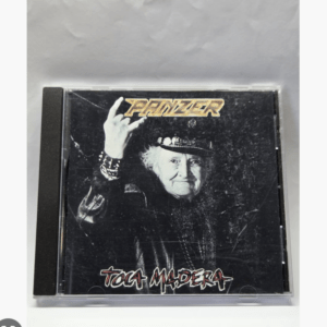 CD case with an elderly woman making a rock hand gesture; 'PANZER' logo at top and 'TOCA MADERA' text at bottom against a dark background.