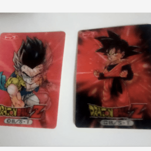 Two Dragon Ball Z trading cards on a white surface: the left card shows a muscular character with dark spiky hair in a battle stance against a red background; the right card features Goku in an orange gi with a red aura background.
