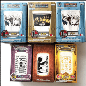 Six boxed glassware collectibles arranged in two rows, with blue, gold, purple, brown, and yellow packaging showing stylized designs and logos.