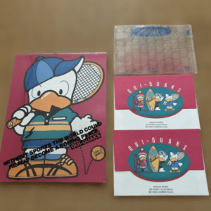 Pink booklet with a cartoon duck in a cap holding a tennis racket; text reads 'Without sports the world could really become a boring place.' Two red-and-white cards with a duck logo sit to the right.