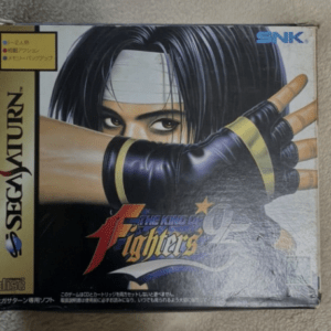 Sega Saturn game box for The King of Fighters '94 featuring a close-up of a masked fighter with bandaged head and black hair, glove-touched foreground.